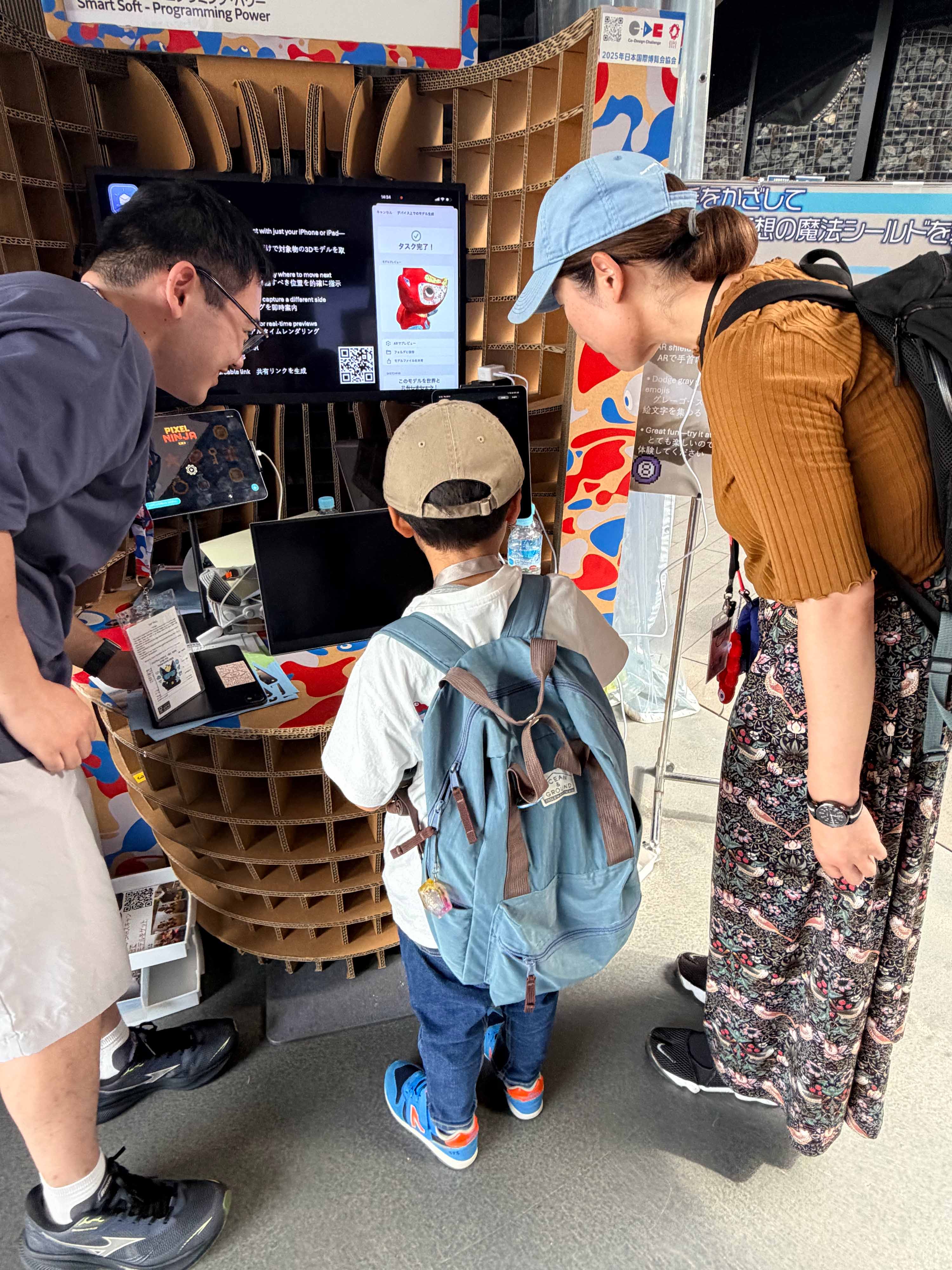 A family trying one of the interactive Expo demos together.