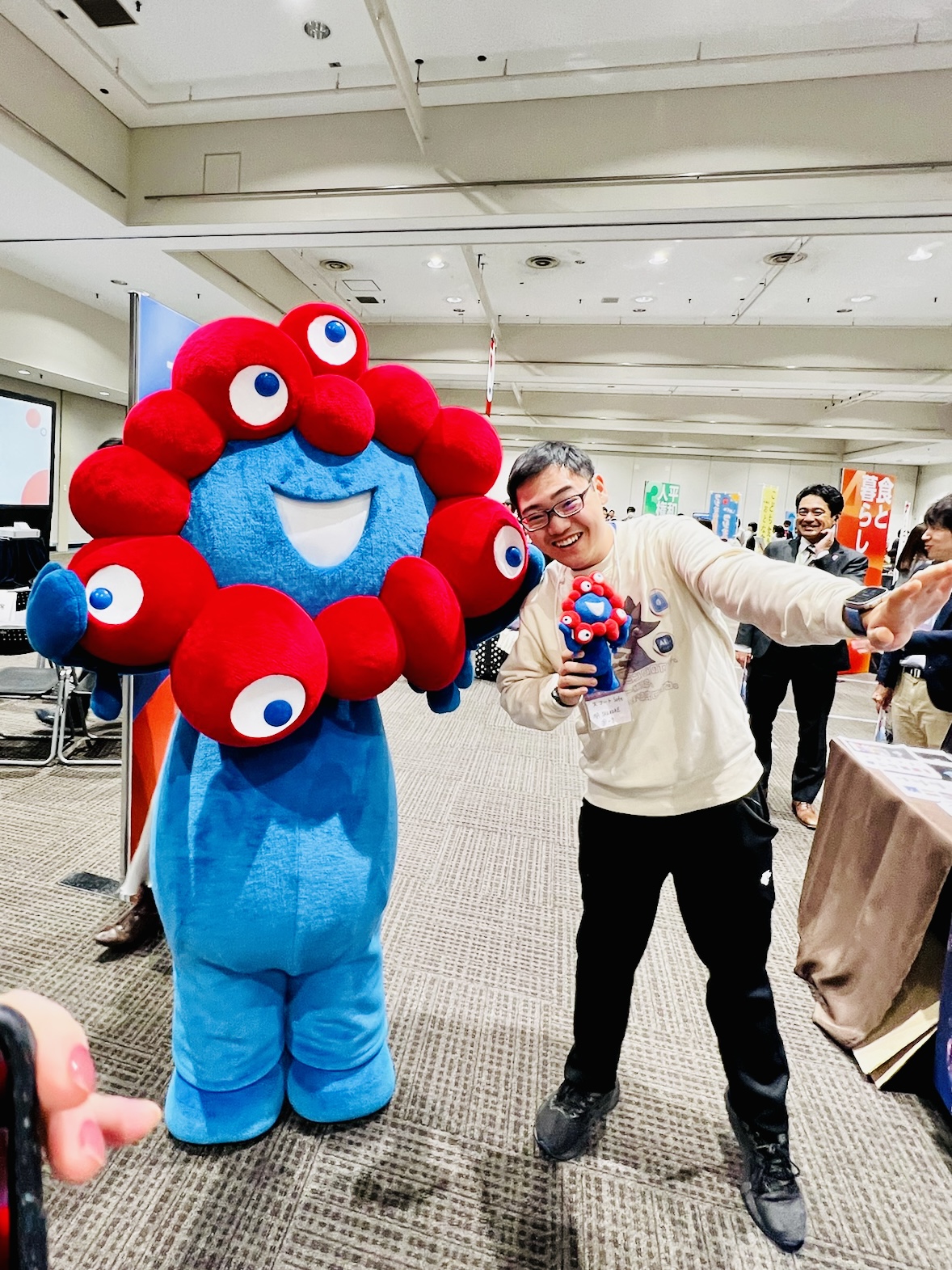 Posing with the Myaku-Myaku mascot during Expo-related preparation.