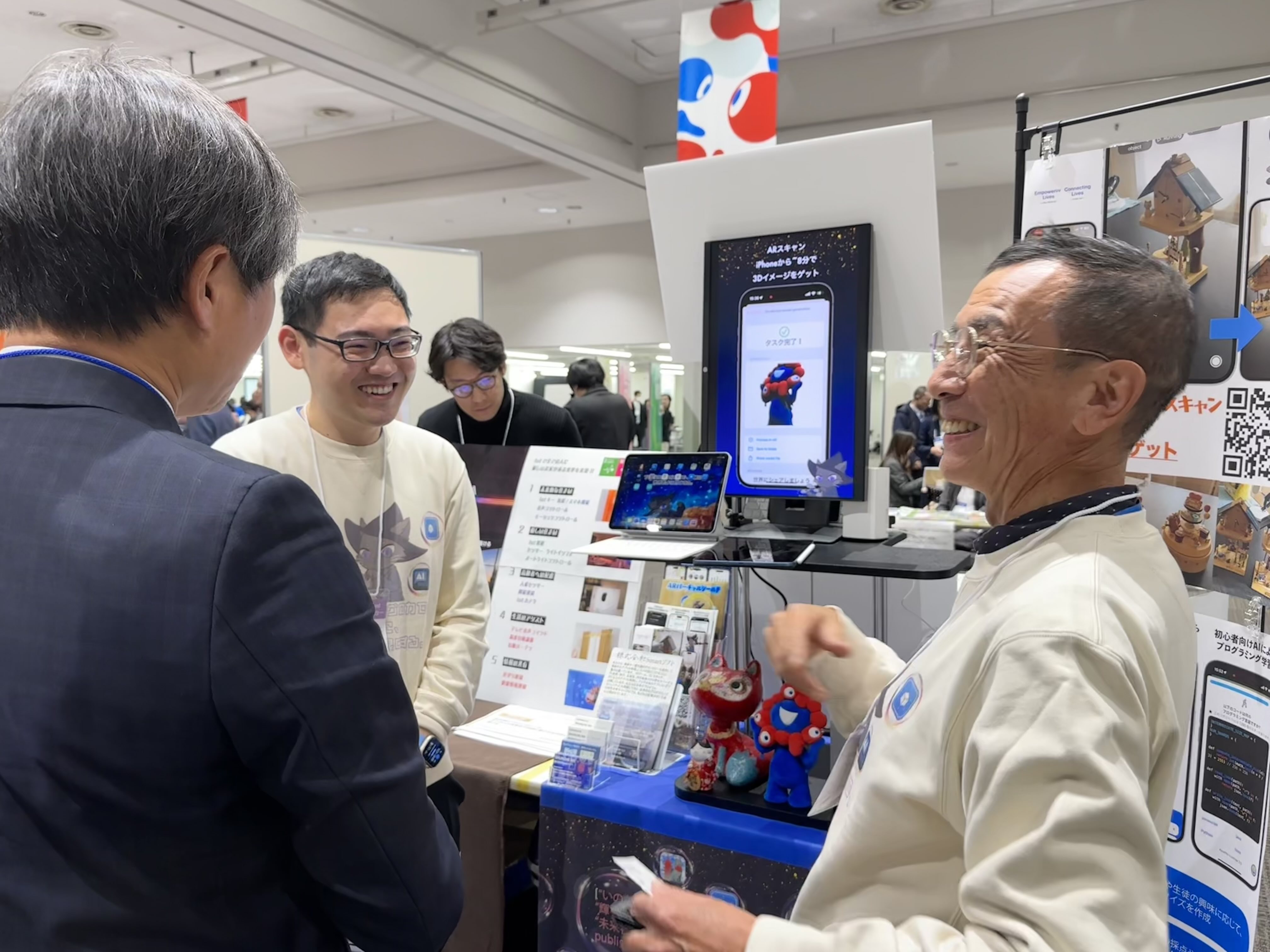 People gathering around an Expo meeting display.